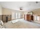 Spacious bedroom undergoing renovations, featuring a ceiling fan, shuttered doors to the outside at 868 Siesta Key Cir, Sarasota, FL 34242