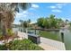Waterfront view from a private boat dock with lush landscaping surrounding the canal at 868 Siesta Key Cir, Sarasota, FL 34242