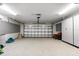 Well-lit garage with epoxy floors, custom cabinets, and ample storage space ready for vehicles at 868 Siesta Key Cir, Sarasota, FL 34242