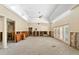 Expansive living room with high ceilings and shuttered doors offering abundant natural light, under renovation at 868 Siesta Key Cir, Sarasota, FL 34242