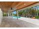 Large patio with ceiling fans, tongue and groove ceiling, columns, and a view of the pool and landscaping at 868 Siesta Key Cir, Sarasota, FL 34242