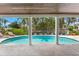 The pool is framed by columns and landscaping for a private, tropical backyard oasis at 868 Siesta Key Cir, Sarasota, FL 34242