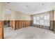 Bright room with natural light and exposed wooden framing, offers versatile potential for renovation at 868 Siesta Key Cir, Sarasota, FL 34242