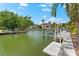 Waterfront property featuring a private dock and scenic views of nearby luxury homes at 868 Siesta Key Cir, Sarasota, FL 34242