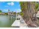 Waterfront property featuring a private dock with boat lift and nearby luxury homes at 868 Siesta Key Cir, Sarasota, FL 34242