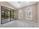 Bedroom with access to screened lanai and arched windows with plantation shutters at 4517 Las Brisas Ln, Sarasota, FL 34238
