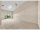 Neutral bedroom with vaulted ceiling, skylight, plush carpeting and a large arched window at 4517 Las Brisas Ln, Sarasota, FL 34238