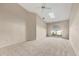 Neutral bedroom featuring plush carpeting, a skylight, vaulted ceilings and a large arched window at 4517 Las Brisas Ln, Sarasota, FL 34238