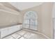 Bright dining area with large arched window, built in cabinets and tile floors at 4517 Las Brisas Ln, Sarasota, FL 34238