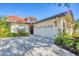 Stylish single-story home featuring a red tile roof, well-maintained landscaping, and a two-car garage at 4517 Las Brisas Ln, Sarasota, FL 34238
