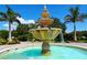 Beautiful three-tiered fountain with stone design, set amidst lush landscaping and paver entry at 4517 Las Brisas Ln, Sarasota, FL 34238