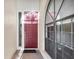 Elegant entryway featuring a paneled red front door, sidelight, and decorative window at 4517 Las Brisas Ln, Sarasota, FL 34238