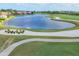 An aerial shot of the meticulously designed golf course with its scenic water hazard and pristine sand traps at 4517 Las Brisas Ln, Sarasota, FL 34238
