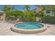 Inviting community hot tub surrounded by a privacy fence with a tile deck and lounge chairs at 4517 Las Brisas Ln, Sarasota, FL 34238