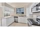 Bright kitchen featuring white cabinets, stainless steel appliances, and a view from the window at 4517 Las Brisas Ln, Sarasota, FL 34238