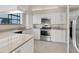 Modern kitchen featuring white cabinets, stainless steel appliances, and neutral countertops at 4517 Las Brisas Ln, Sarasota, FL 34238
