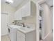 Well-lit laundry room offers lots of cabinets, washer, dryer, sink and easy access to outdoors, making chores a breeze at 4517 Las Brisas Ln, Sarasota, FL 34238