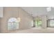 Bright living room with large windows, vaulted ceilings, and a modern chandelier at 4517 Las Brisas Ln, Sarasota, FL 34238
