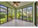 Bright sunroom surrounded by lots of windows and a ceiling fan overlooking the beautiful backyard landscaping at 4517 Las Brisas Ln, Sarasota, FL 34238