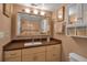 Bathroom with a vanity with large mirror, framed art, and white toilet at 10423 Waterbird Way # 10423, Bradenton, FL 34209