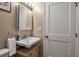 Bathroom with wall-mounted sink, vanity and white door at 10423 Waterbird Way # 10423, Bradenton, FL 34209