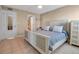 Well-lit bedroom with tile floors, a ceiling fan, and an adjacent bathroom, providing convenience and comfort at 10423 Waterbird Way # 10423, Bradenton, FL 34209