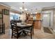 Cozy dining area with a round table and view of the kitchen and front entrance at 10423 Waterbird Way # 10423, Bradenton, FL 34209