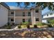 Two-story condo with white exterior, balcony, and well-maintained landscaping at 10423 Waterbird Way # 10423, Bradenton, FL 34209