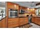 Well-equipped kitchen with stainless steel appliances and wooden cabinetry at 10423 Waterbird Way # 10423, Bradenton, FL 34209