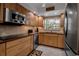 Kitchen with stainless appliances, tile backsplash and wood cabinets at 10423 Waterbird Way # 10423, Bradenton, FL 34209