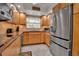 Modern kitchen featuring stainless steel appliances and tile flooring at 10423 Waterbird Way # 10423, Bradenton, FL 34209