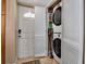 Laundry area with stacked washer and dryer and a white door at 10423 Waterbird Way # 10423, Bradenton, FL 34209