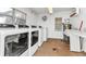 Bright laundry room featuring multiple high efficiency washing machines and a convenient utility sink at 10423 Waterbird Way # 10423, Bradenton, FL 34209