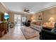Cozy living room with a ceiling fan and sliding glass doors leading to a waterfront view at 10423 Waterbird Way # 10423, Bradenton, FL 34209