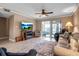Spacious living room featuring a ceiling fan, comfortable seating, and a waterfront view at 10423 Waterbird Way # 10423, Bradenton, FL 34209