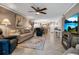 Comfortable living room with a sofa, recliners, tile floors, and access to the dining and kitchen areas at 10423 Waterbird Way # 10423, Bradenton, FL 34209