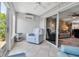 Relaxing sunroom area featuring tiled floors, a ceiling fan, and seamless access to the living room at 10423 Waterbird Way # 10423, Bradenton, FL 34209