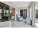 Bright sunroom area with tiled floors, multiple sliding doors, and partial views of the interior living spaces at 10423 Waterbird Way # 10423, Bradenton, FL 34209