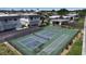 A view of the community tennis court with basketball hoop, offering recreational opportunities for residents at 10423 Waterbird Way # 10423, Bradenton, FL 34209