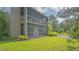 A condo featuring a large screened-in porch and expansive backyard with a grass lawn at 107 Woodland Pl # 107, Osprey, FL 34229