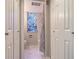 Hall bathroom with decorative window, walk-in shower, and ample storage at 107 Woodland Pl # 107, Osprey, FL 34229