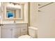 Bathroom featuring a bright vanity, sink, and decorative window at 107 Woodland Pl # 107, Osprey, FL 34229