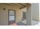 Condo entryway featuring a screen door, terra cotta tiles, and a glimpse of the interior at 107 Woodland Pl # 107, Osprey, FL 34229
