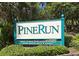 Welcoming sign to the Pine Run community entrance at 107 Woodland Pl # 107, Osprey, FL 34229