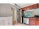 Functional kitchen with stainless steel appliances and a view into the living area at 107 Woodland Pl # 107, Osprey, FL 34229