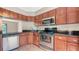 Well-equipped kitchen featuring stainless steel appliances and dark granite countertops at 107 Woodland Pl # 107, Osprey, FL 34229