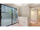 Bright room featuring sliding doors to a wood deck and a storage cabinet at 107 Woodland Pl # 107, Osprey, FL 34229