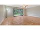 Bright living room featuring tile floors, a ceiling fan, and sliding glass doors to a screened lanai at 107 Woodland Pl # 107, Osprey, FL 34229