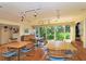 Bright meeting room featuring hardwood floors, large windows, and ample space for gatherings at 107 Woodland Pl # 107, Osprey, FL 34229