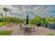 Outdoor patio with furniture, grilling space, and a view of the fountain at 107 Woodland Pl # 107, Osprey, FL 34229